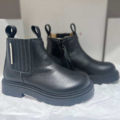 Black Chelsea boots on a white background